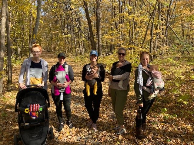 ladies holding babies in the woods